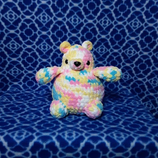 A multicolored bear on a blue background