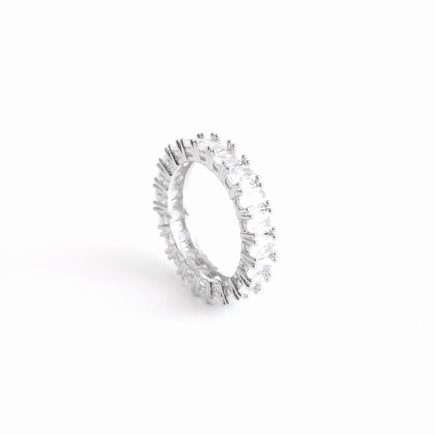 Oval Amor band ring on its side against a white backdrop