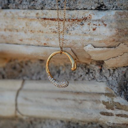 Time to shine necklace against a stone backdrop
