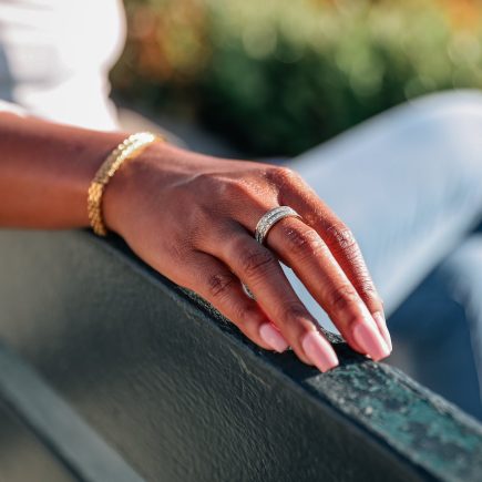 Be extra ring on model hand paired with risk taker bracelet
