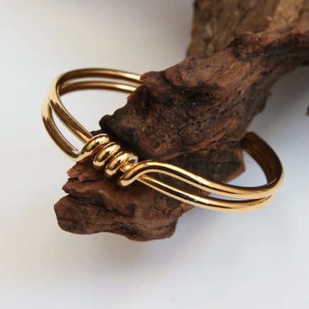 Two banded Gold  surrounded bracelet with a front wrap around detail 